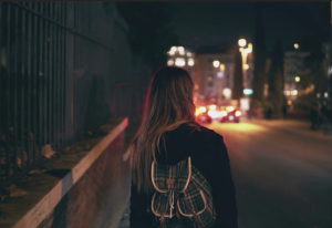 Woman Walking on a Dark Street